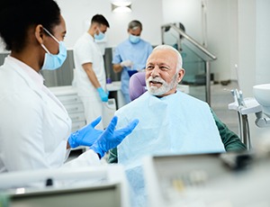 Dentist talking to smiling patient