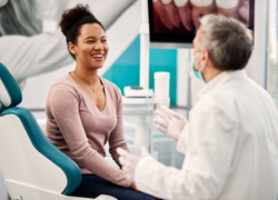 a patient smiling while visiting her dentist