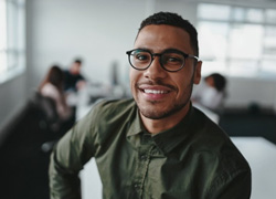 a man smiling confidently at the workplace