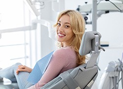 Woman smiling while sitting in treatment chair