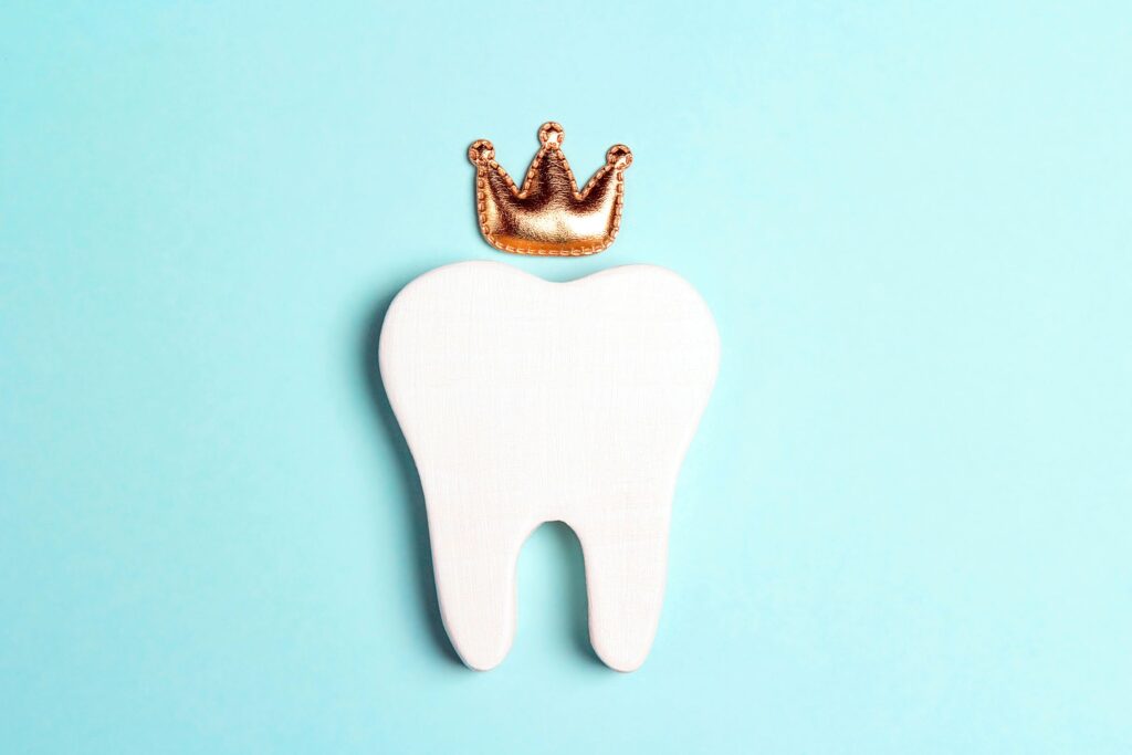 Crown over flat model tooth on light teal background