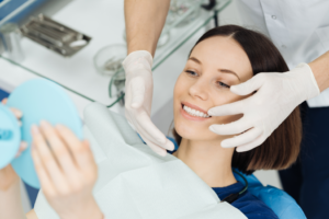 a patient admiring their smile in a mirror